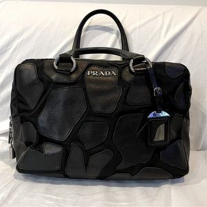 Prada leather and nylon handbag in black with padlock.